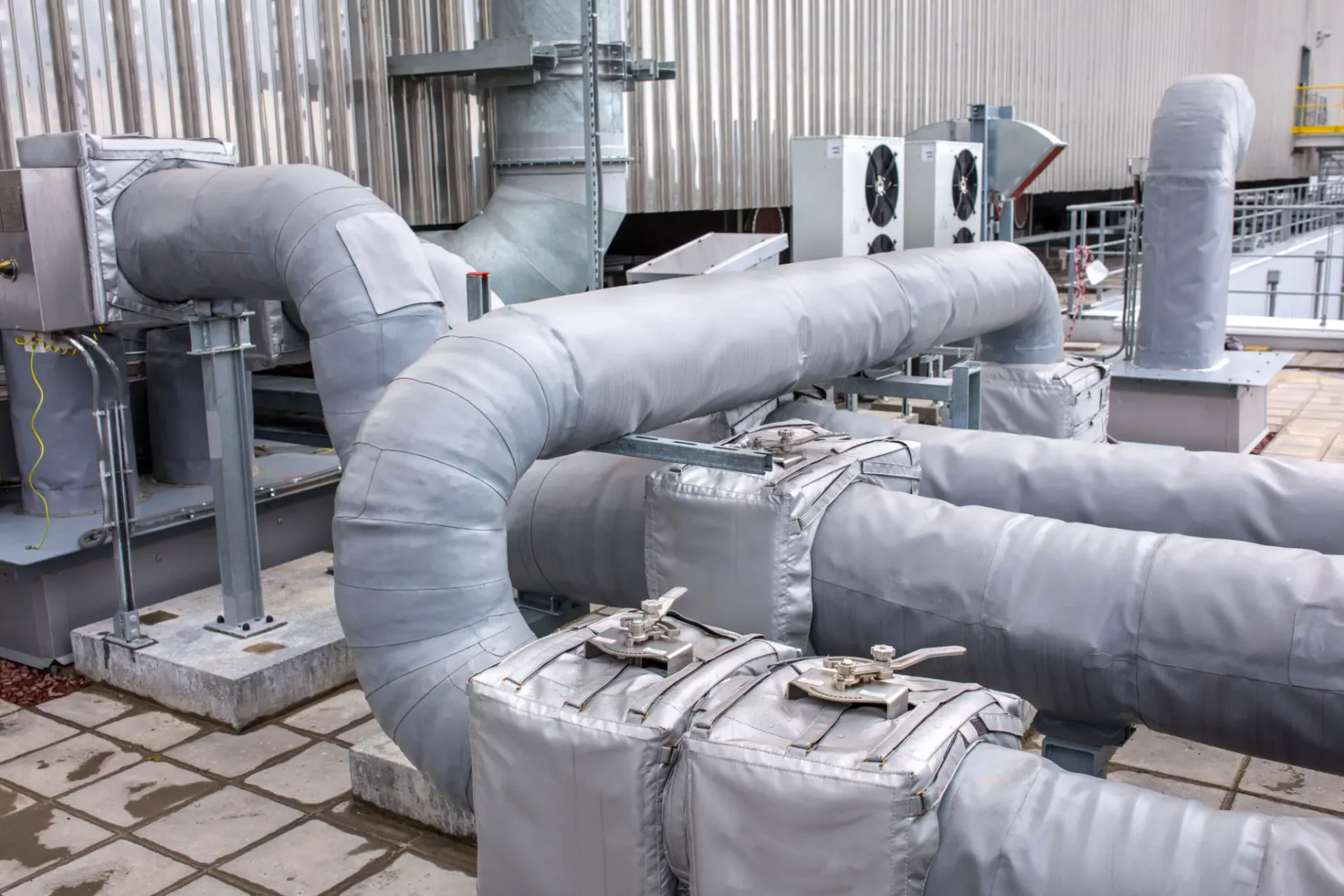 Insulated industrial pipes on rooftop system.