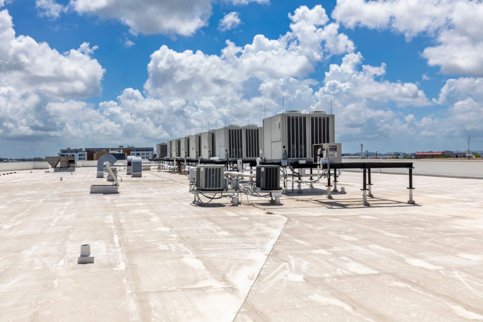 Rooftop HVAC units under a cloudy sky.